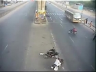 Small car trying to over take a truck, smashes a biker. Lucky.